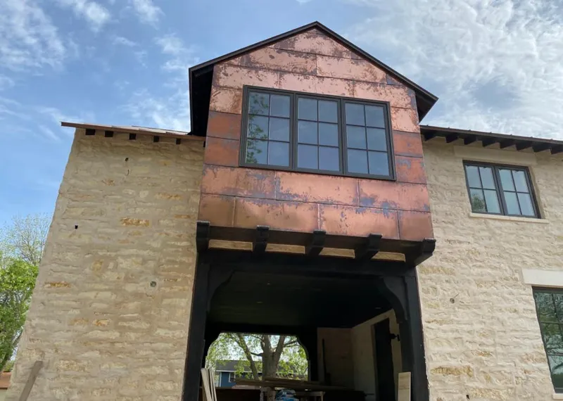 Copper metal panel facade on a stone building for Skylight Installation in Macon-Bibb County