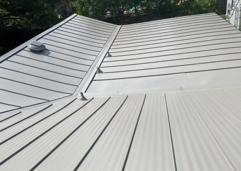 Solar attic fan installed on a metal roof for Roof Ventilation in Macon-Bibb County